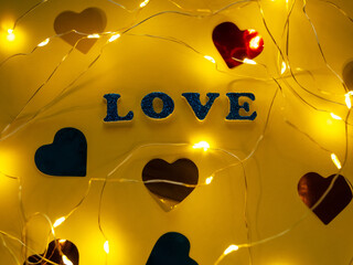 Valentine's Day Love glitter sign text on pastel yellow background hearts confetti, creative flatlay minimal concept. Greeting card top view social media sale banner design. Bright vebrant colors.