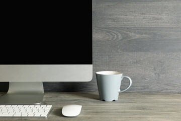 Minimalist workspace concept with desktop computer on gray background