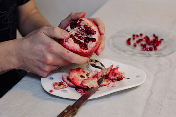 Man brushing pomegranate fruit with his hands