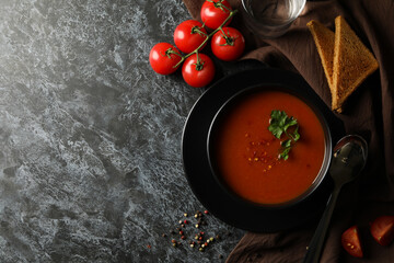 Concept of tasty food with tomato soup on black smokey background