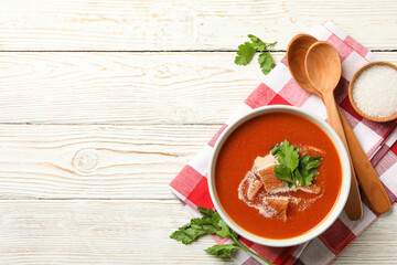 Concept of tasty food with tomato soup on wooden background