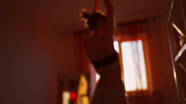 blurred footage of sensual woman wearing in lingerie dancing in bedroom against sunny window