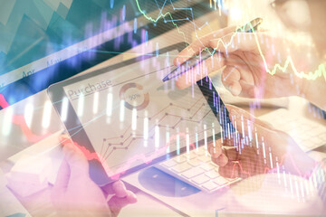Double exposure of man's hands holding and using a phone and financial chart drawing. Market analysis concept.