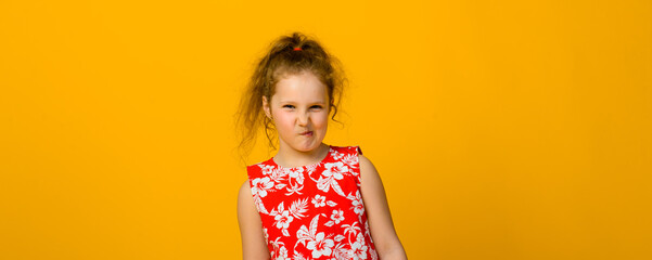 Happy child emotions. Energetic, angry, surprised joyful adorable little girl on studio background.