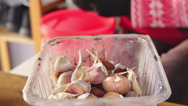 The process of separating the cloves of garlic from the head with a gloved knife
