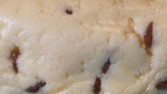 Fresh cheese with cumin. Cumin sprinkled on cheese. The tray rotates. Selective focus