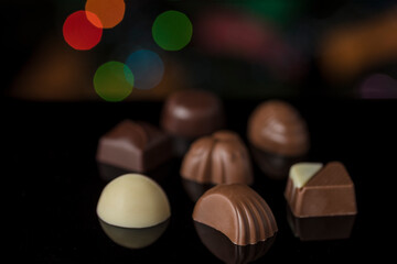 Selective focus shot of delicious chocolate candies on a bokeh background