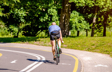 Cyclist ride on the bike path in the city Park
