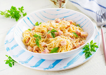 Classic homemade carbonara pasta with pancetta, egg, hard parmesan cheese and cream sauce. Italian cuisine. Spaghetti alla carbonara.