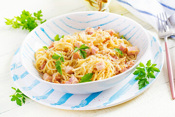 Classic homemade carbonara pasta with pancetta, egg, hard parmesan cheese and cream sauce. Italian cuisine. Spaghetti alla carbonara.