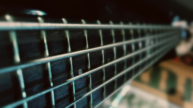 Bass guitar strings macro in slow motion.