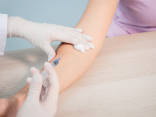 Persons administering vaccinations, doctor use hand cleansed with an alcohol-based giving vaccine injection to a patient. protection and antibiotic for coronavirus, flu. healthcare concept.