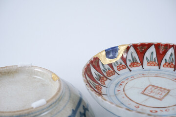 Kintsugi with different color mix , gold cracks Kintsugi, Kintsukuroi Japanese technique.