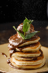 Pancakes with ice cream, chocolate and mint close up