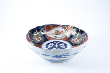 colourful Imari bowl restored with Kintsugi , gold cracks Kintsugi, Kintsukuroi Japanese technique.