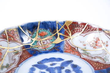 colourful Imari bowl restored with Kintsugi , gold cracks Kintsugi, Kintsukuroi Japanese technique.