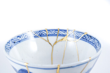 Kintsugi detail closeup, real gold wabi sabi Kintsukuroi, Japanese artisan work. Kintsugi, the beauty of imperfections.