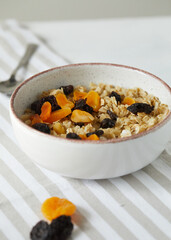 Porridge with dried fruits, prunes and dried apricots close up