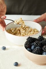Porridge in a white bowl blackberries