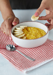 Millet porridge with bananas in the white plate