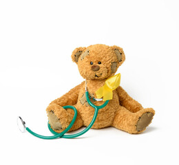 Cute brown teddy bear with a patch, a silk yellow ribbon in the shape of a loop