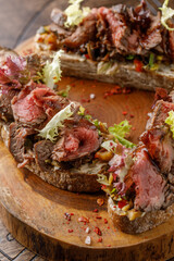 Bread with meat and lettuce leaves close up