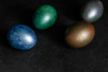 colorfull marble painted easter eggs on black background. Concept of minimal festive Easter backdrop
