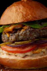 Close up of juicy burger on the wooden board