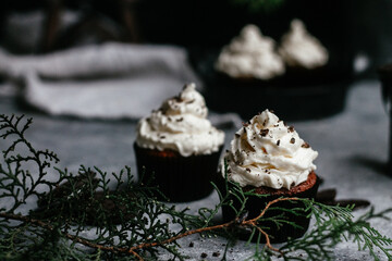 chocolate muffins with cream on gray background