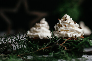 chocolate muffins with cream on gray background