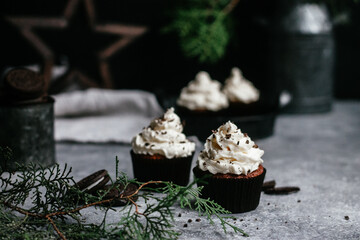 chocolate muffins with cream on gray background