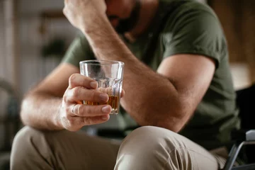 Fototapete Rund Depression man in wheelchair drinking alcohol at home. Lonely man is addicted of alcohol. © JustLife