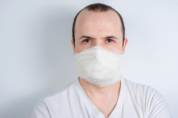 man in a medical mask on a white background, protection against viruses and bacteria