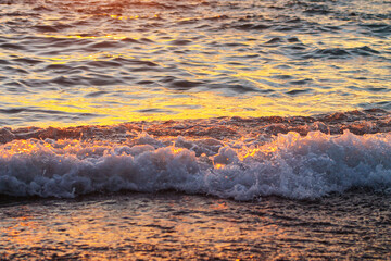 Tidal wave on sea at sunset closeup