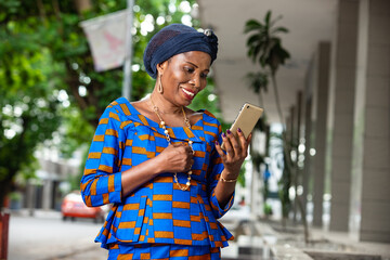 portrait of a beautiful african businesswoman with mobile phone, smiling.