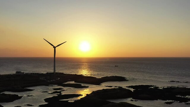 Drone video showing red sunset and windmill