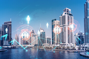 Skyscrapers of Dubai business downtown. International hub of trading and financial services. Social network icons hologram, concept of people connection. Double exposure. Dubai Canal waterfront.