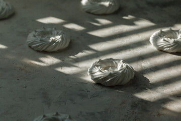 Meringue in a box on a light table in the shade.