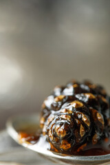 Jam of cones in a spoon close-up.