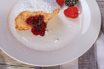 Berliner jelly filled doughnut with raspberry and blackberry.