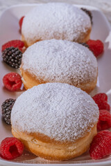 Berliner jelly filled doughnut with raspberry and blackberry.