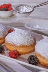 Berliner jelly filled doughnut with raspberry and blackberry.