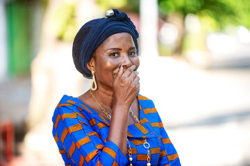 beautiful adult business woman hiding her smile with her hand.