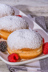 Berliner jelly filled doughnut with raspberry and blackberry.