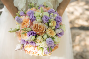 A wedding bouquet in the hands of bride close-up.