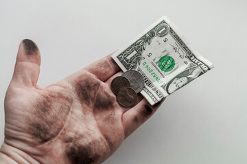 coins money in dirty hand on white background, poverty concept
