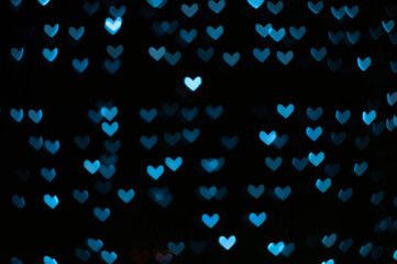 Color Bokeh on a dark background with hearts for use in graphic design