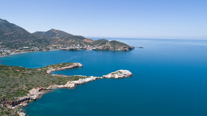 Great landscape of the island from a bird's-eye view. Blue sea, clear sky, rocks, road, cliff and green mountains.