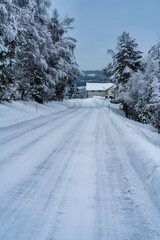 Fototapeta premium Road covered in ice and snow in the winter. Making it both slippery and dangerous.