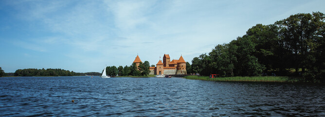 TRAKAI, LITHUANIA - JULY 29, 2017: Photo editor, A beautiful medieval castle surrounded by a lake.